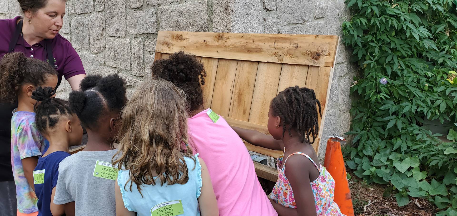 children looking in a compost bin